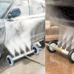 High-pressure undercarriage pressure washer attachment spraying water beneath a car for rust prevention and deep cleaning.